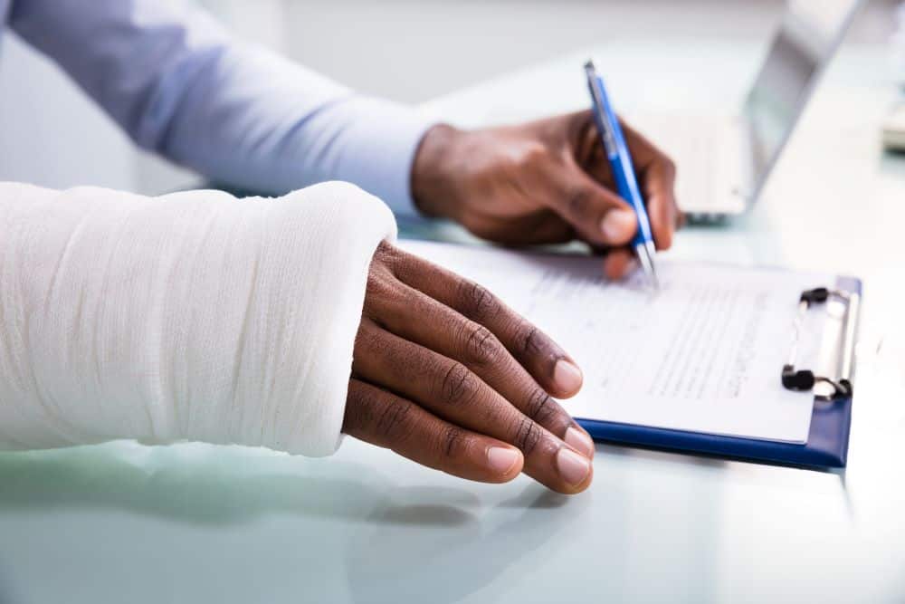 filling out paperwork in a cast