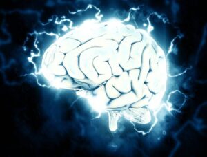 An animation of a brain with neuron charges around it to represent traumatic brain injury affecting the brain after an accident.