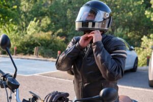 motorcycle helmet being put on